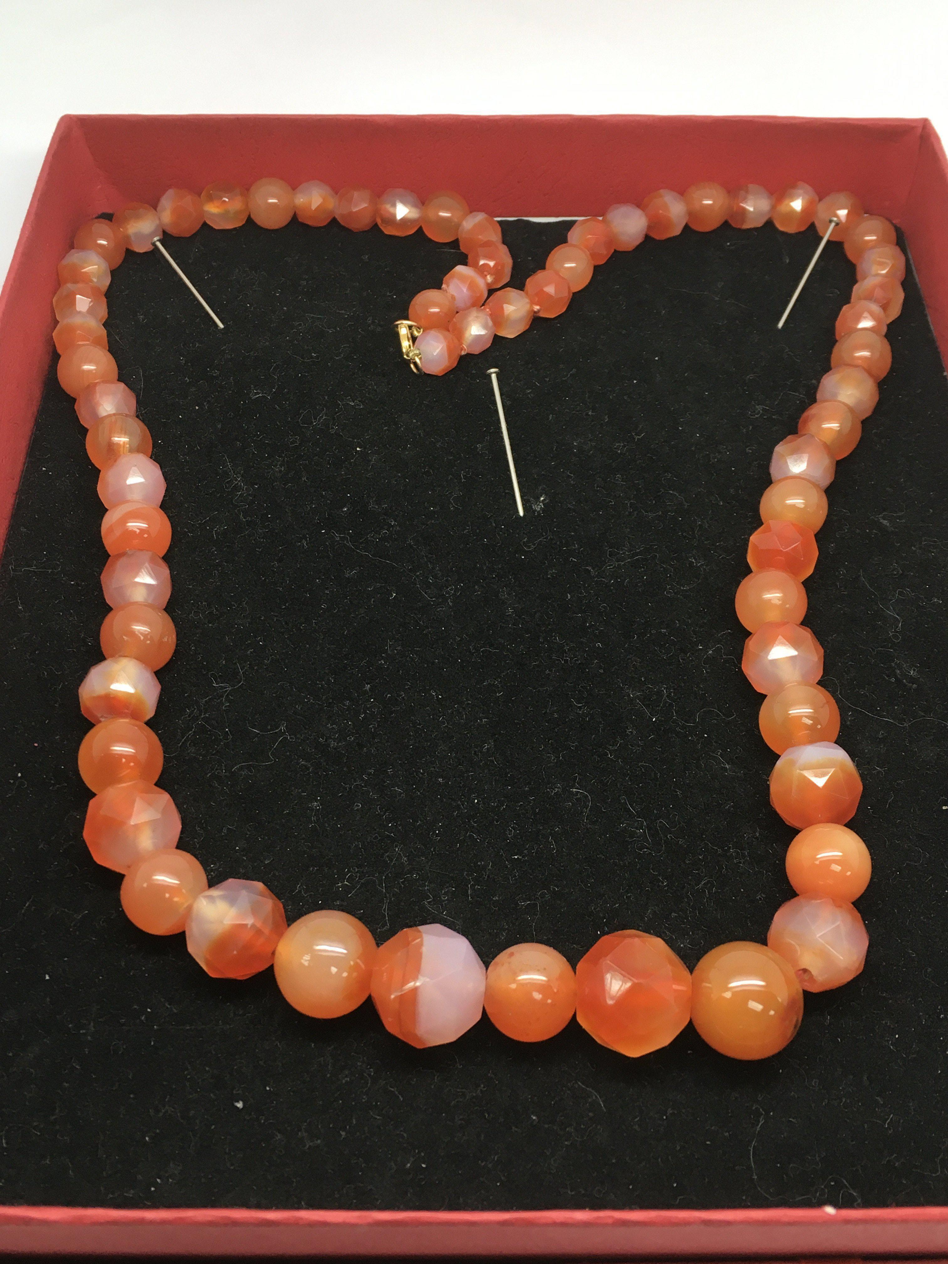 A cornelian bead necklace with round and facet cut