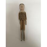 An old carved wood and painted peg doll.