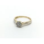 An 18carat gold ring set with a round cluster of d