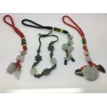 Three Chinese jade amulet pendants and one bracele