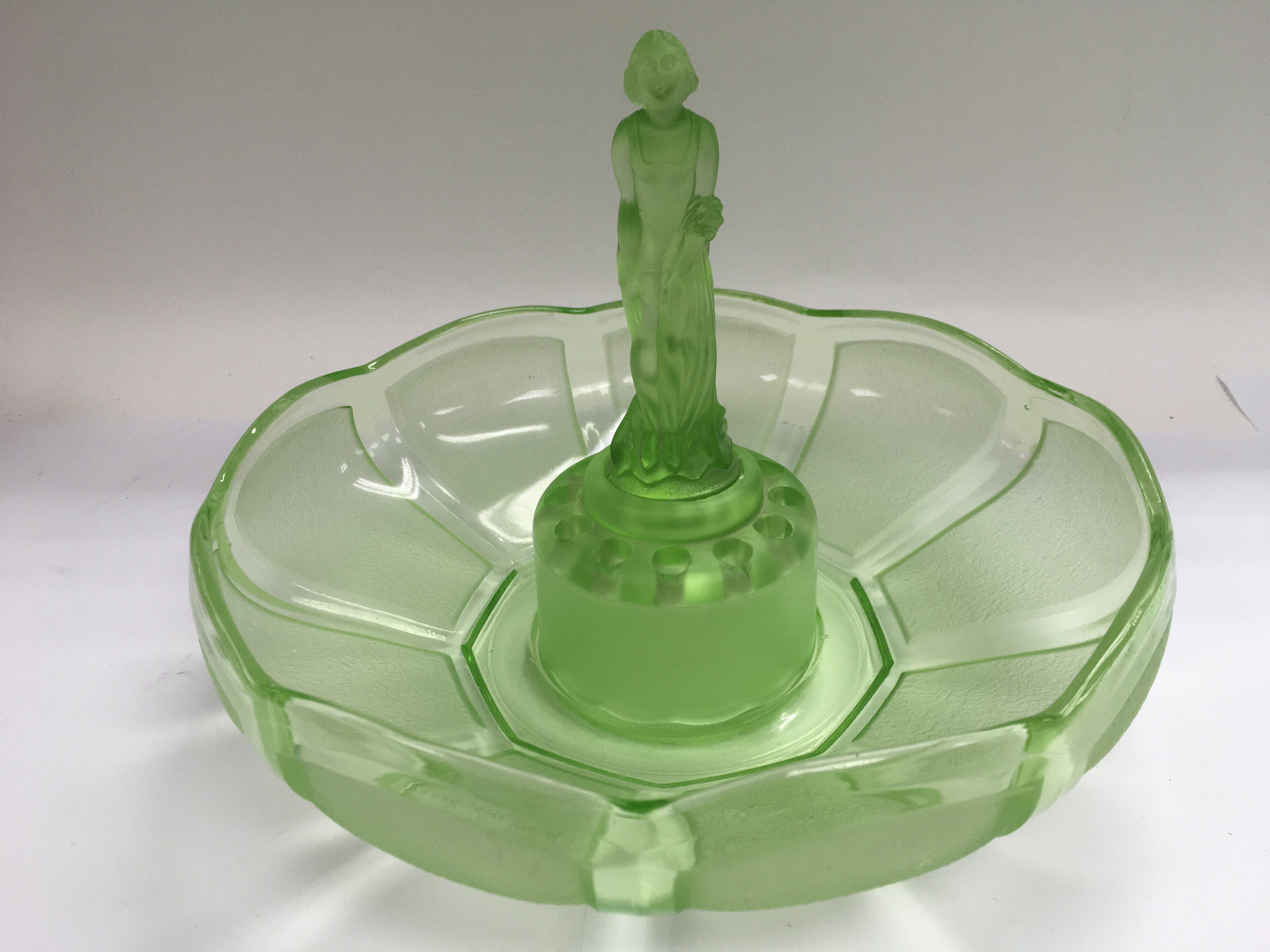 An Art Deco style green glass centrepiece with female figure to the centre.