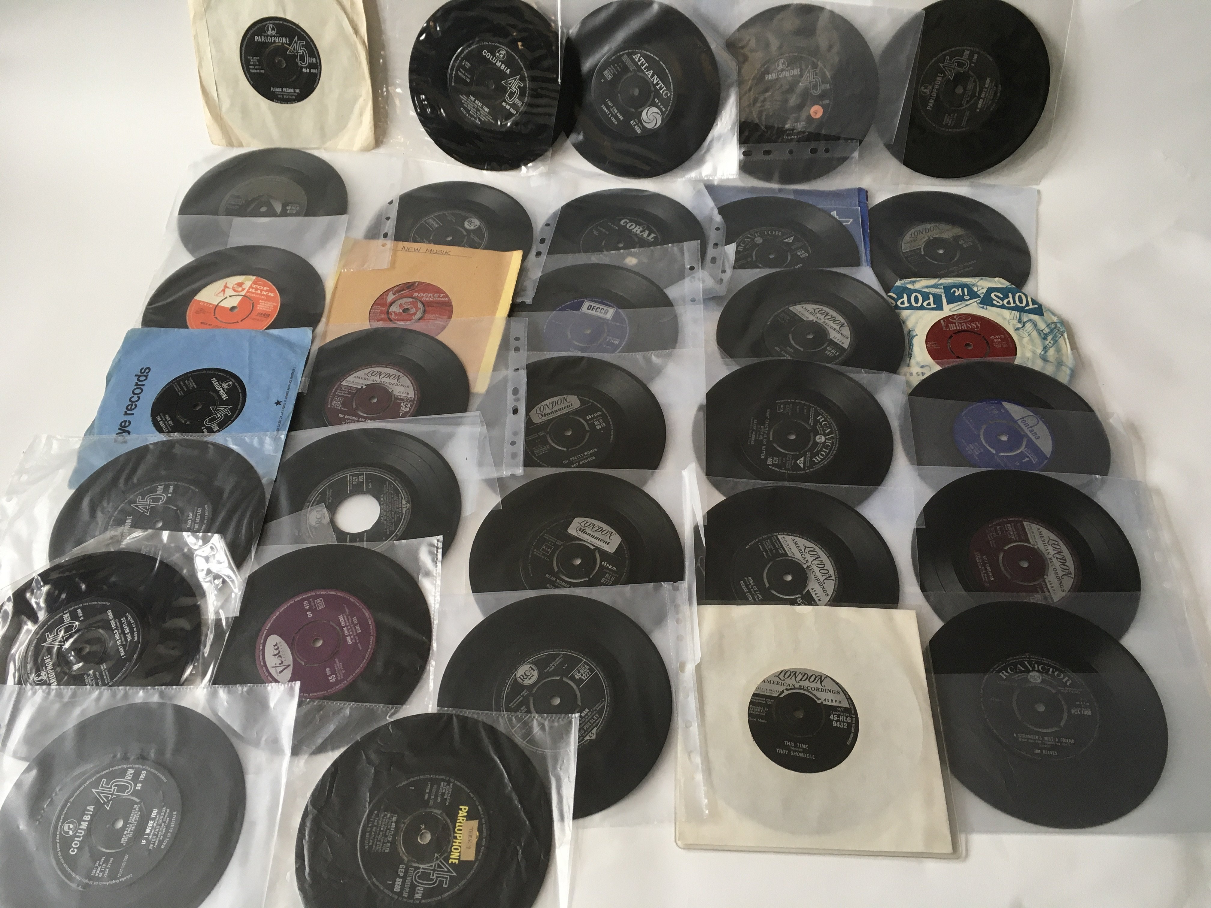 A collection of 7inch singles and EPs by various artists including The Beatles, Elvis Presley, Roy