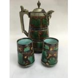 A Majolica jug with silver plated mounts 25 cm and a pair of similar vases 10 cm .