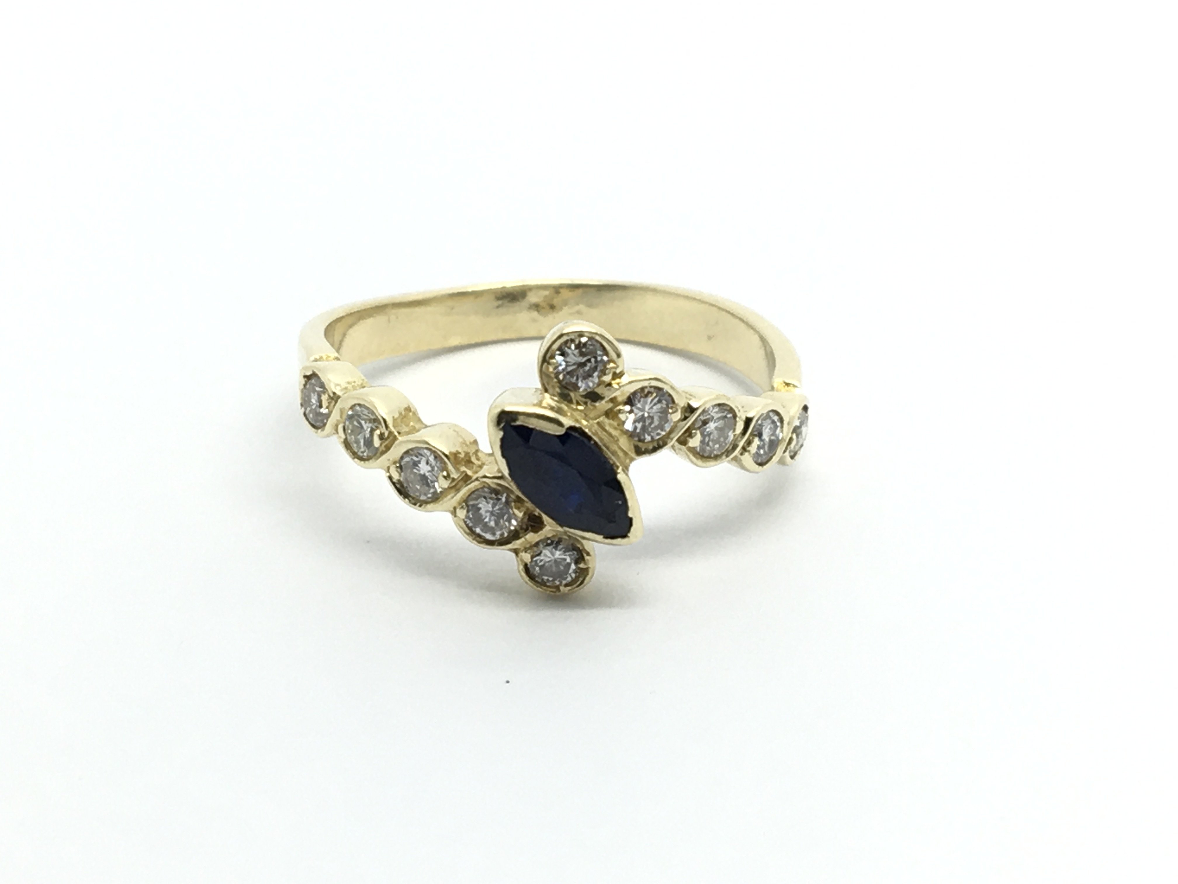 An unmarked gold ring set with a sapphire with a s