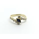 An unmarked gold ring set with a sapphire with a s