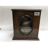 A small oak smokers cabinet with tobacco jar.