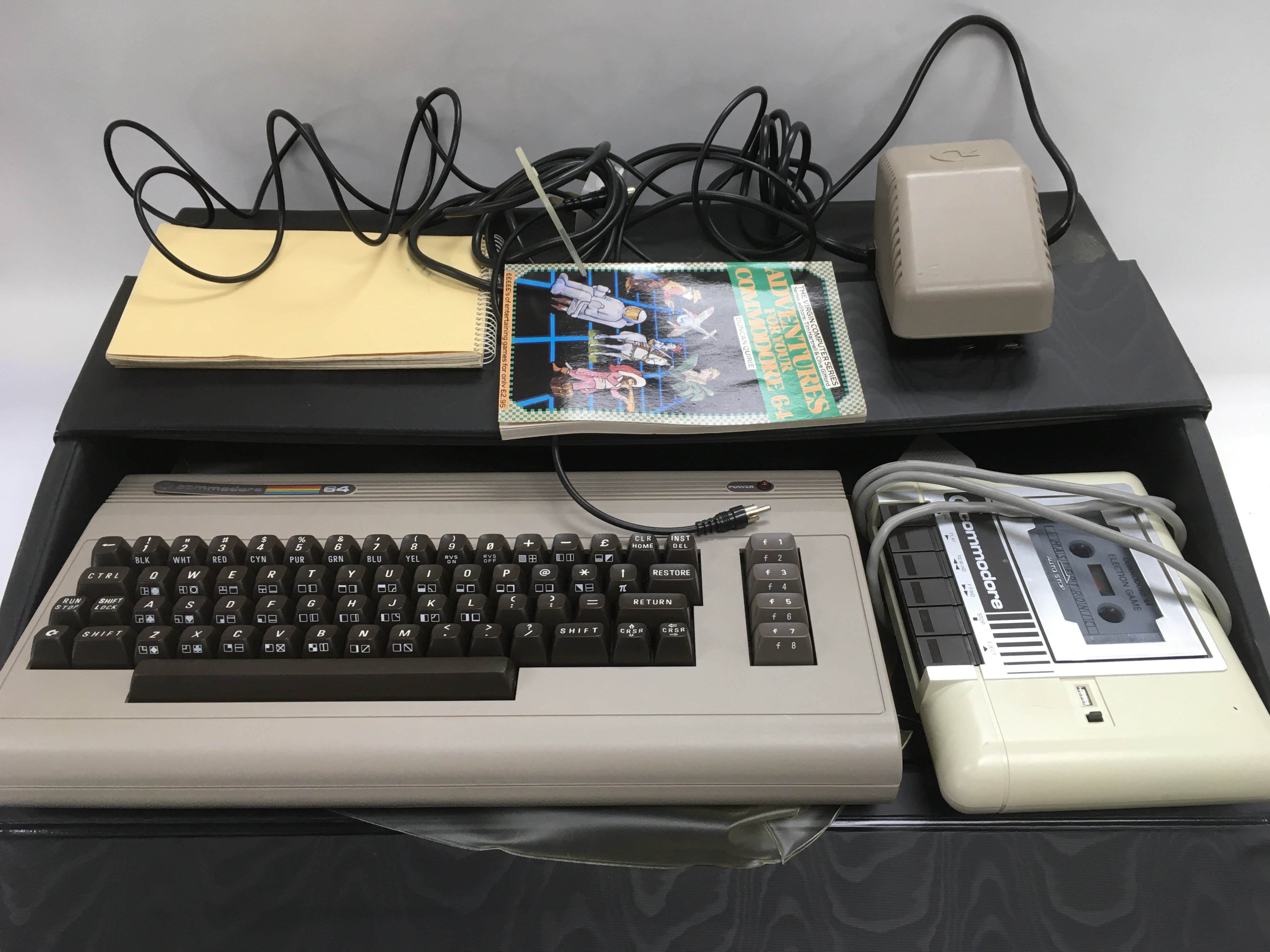 A cased Commodore 64 home computer, cassette playe