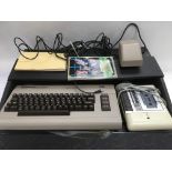 A cased Commodore 64 home computer, cassette playe