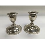 A pair of small silver candlesticks, Sheffield hallmarks.
