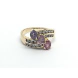An unusual 9carat gold ring set with pink sapphire amethyst and four rows of brilliant cut