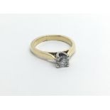 An unmarked gold ring possible 18carat gold ring set with a solitaire diamond approximately 0.33