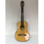 A Marco Polo classical guitar, possibly by Yairi of Japan, comes supplied with a hard carry case.