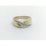 A 9carat gold ring set with a row of brilliant cut
