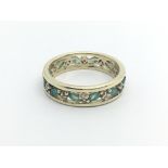 A 9carat gold ring set with a row of emerald and diamonds ring size T.