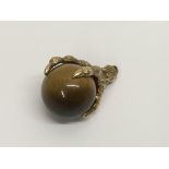 A 9 ct gold claw tigers eye charm