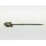 An antique silver gilt stickpin, the top decorated