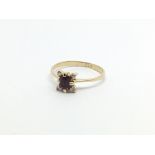 A 9carat gold ring set with a small ruby with a di