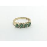 An 18carat gold ring set with four Marquise Emeral