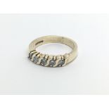 An 18carat gold ring set with a row of of five diamonds ring size L