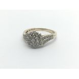 A 9carat gold diamond cluster ring set with a patt