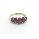 A 9carat gold ring set with oval graduating red stones ring size P.