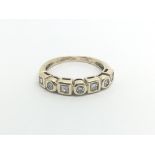 A 9carat gold ring set with alternating princess c