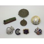 A collection of badges and medals including enamel