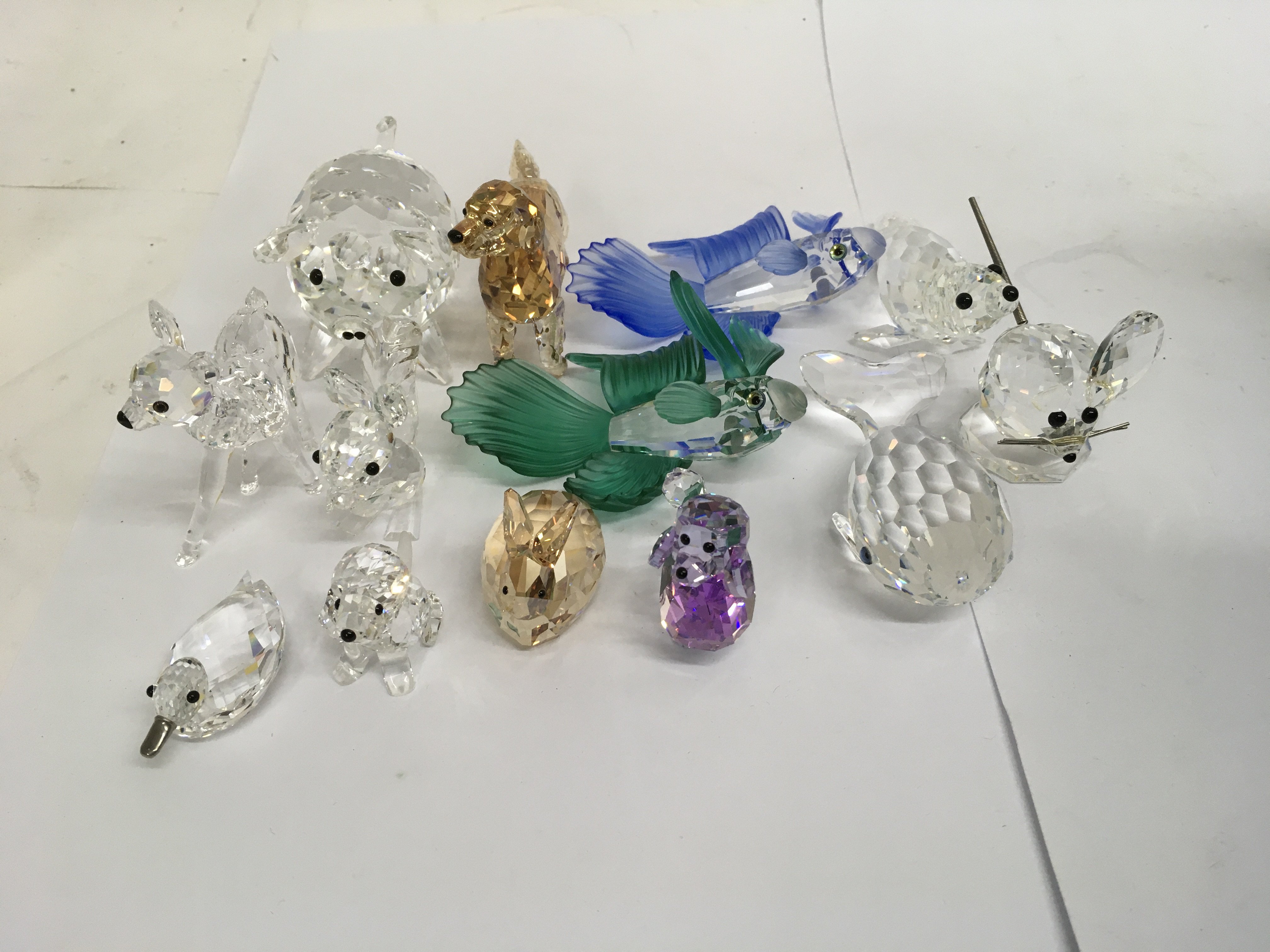 A collection of cut glass animal figures including