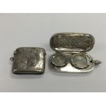 A silver double sovereign case and a silver vesta