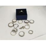 A collection of rings including silver and a boxed