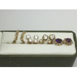 Four pairs of 9ct gold earrings, one pair set with amethyst, two with clear stones plus one other