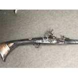 A late 18th century or early 19th century Jazail rifle with a steel flint lock action bone inlaid