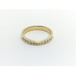 An 18carat gold ring set with a row of brilliant c