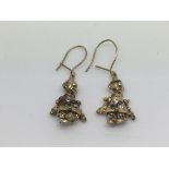 A pair of 9ct gold earrings in the form of articul