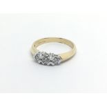 An 18carat gold ring set with three diamonds approximately 0.20 of a carat ring size M.