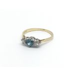 An18carat gold ring set with a Topaz flanked by di