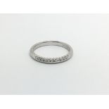 An 18carat white gold ring set with a row of brill