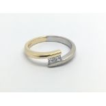 A modern design white and yellow gold ring set with two princess cut diamonds 0.20 of a carat ring