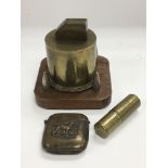 Three trench art items comprising a table lighter,