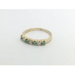 An 18carat gold ring set with a row of emeralds an