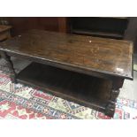 An oak coffee table of rectangular shape with a cross banded edge on turned legs united by an
