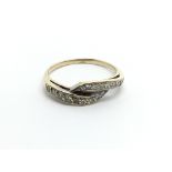 An unmarked gold ring set with diamonds ring size