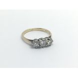 A 9carat gold ring set with three diamonds Approximately 0.40 of a carat ring size J.