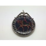 A silver and enamel crown coin pendant.