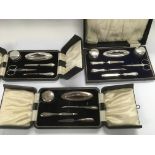 Three boxed silver manicure sets.