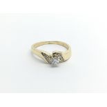 An 18carat gold ring set with a brilliant cut diamond flanked by smaller diamond ring size IJ