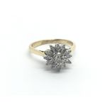 An 18carat gold ring set with a floral pattern of diamonds. ring size M.