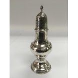 A silver sugar caster, London 1785, approx height