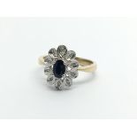 A 9carat gold ring set with a blue sapphire and sm