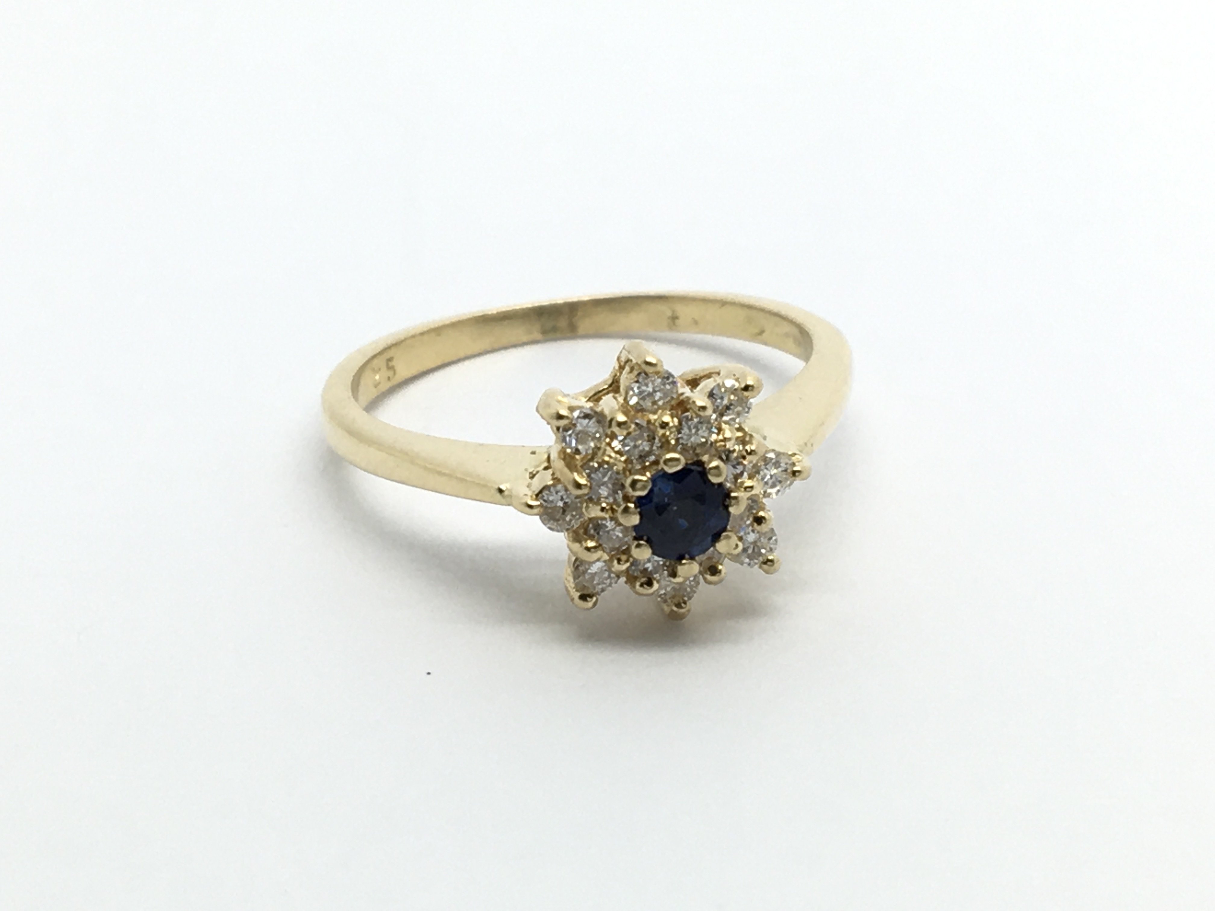 An 18carat gold ring set with a blue sapphire a di